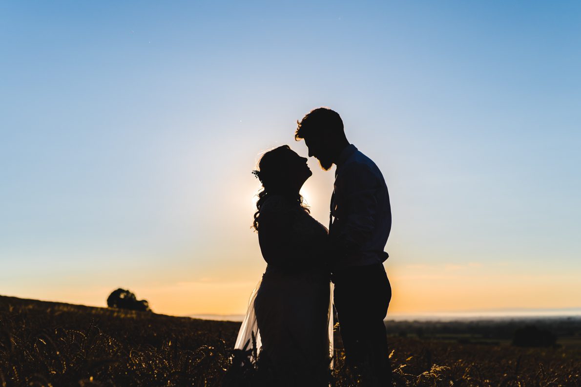 a bride and groom in the sunset at coombe lodge